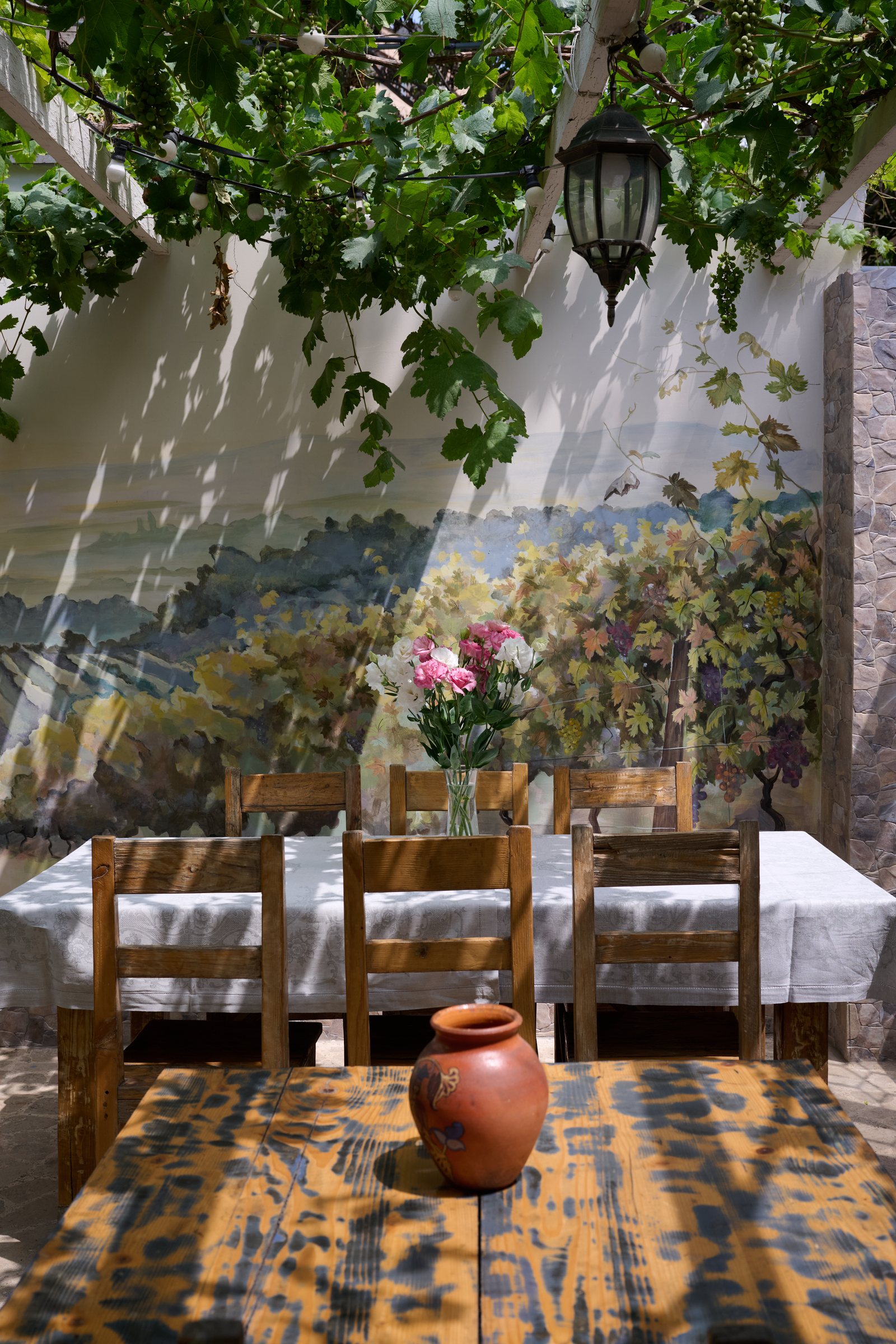 Dining room with framed family photographs and patterned wallpaper