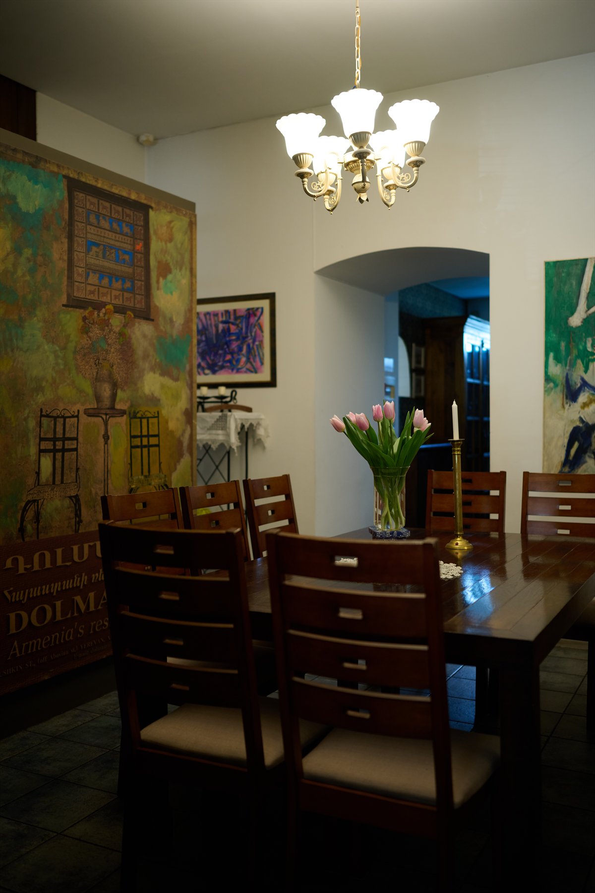 Dolmama dining room with mural, chandelier and wooden table