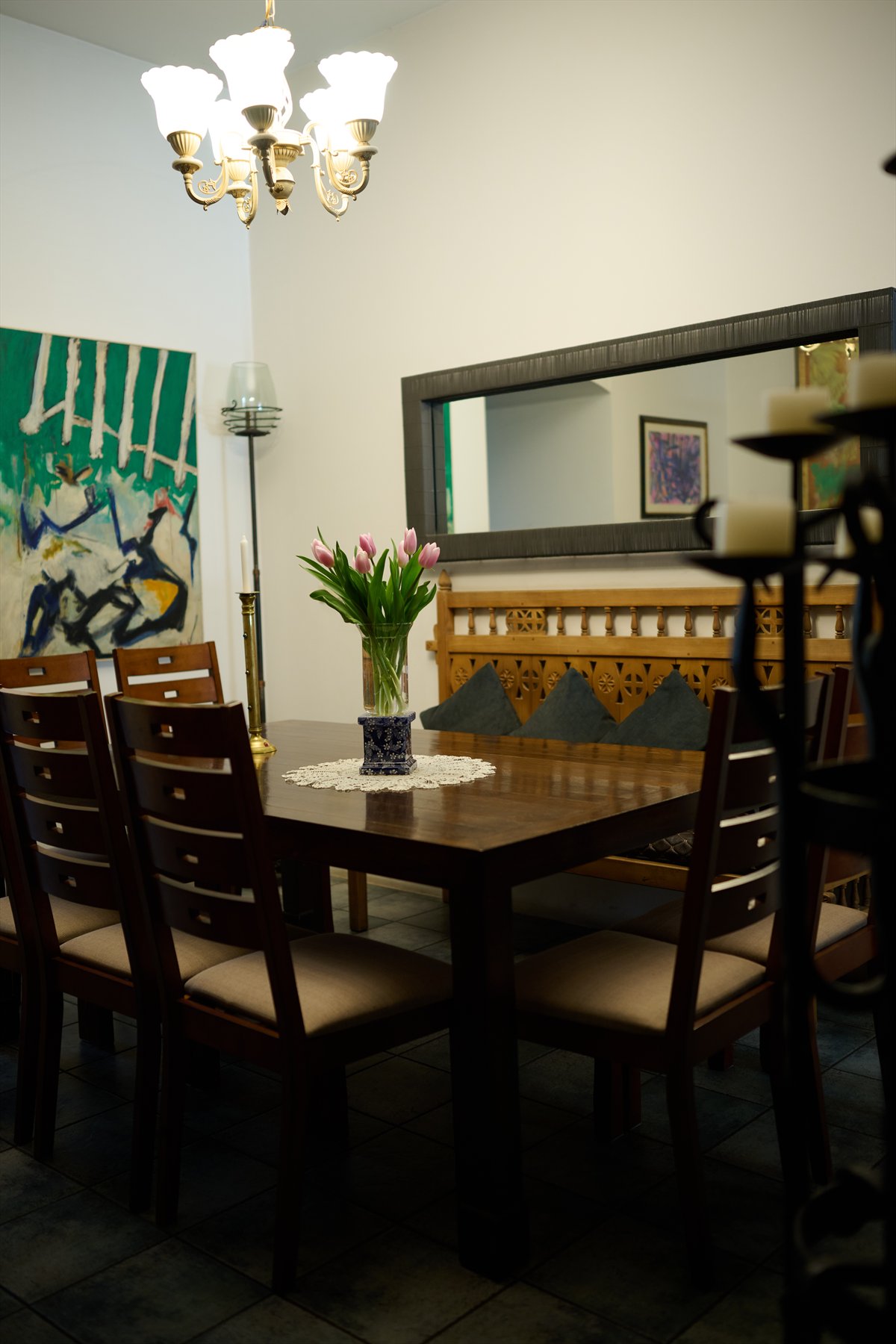 Dolmama dining room with mirror, chandelier and flower arrangement