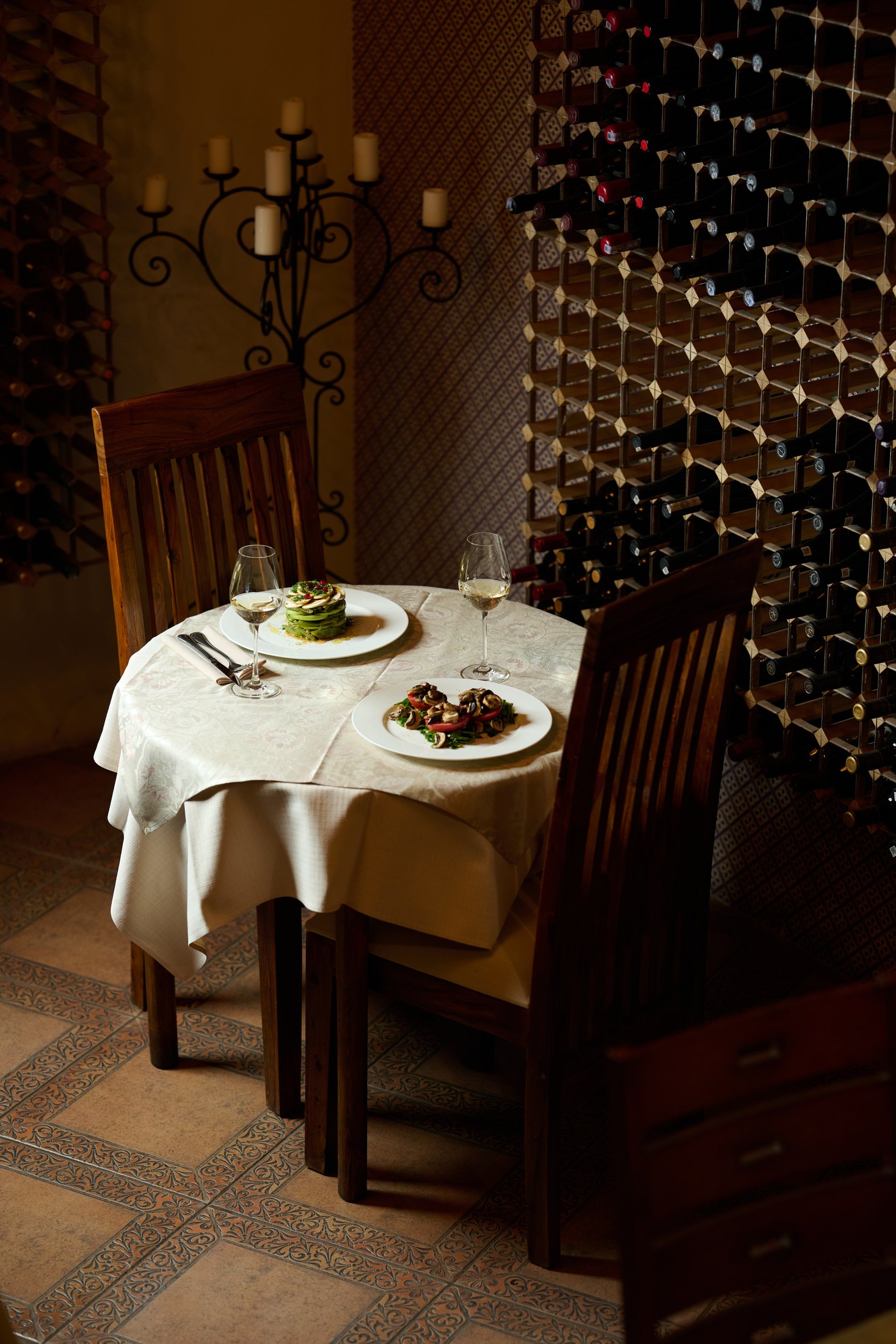 Private Dolmama wine room table with bottle wall