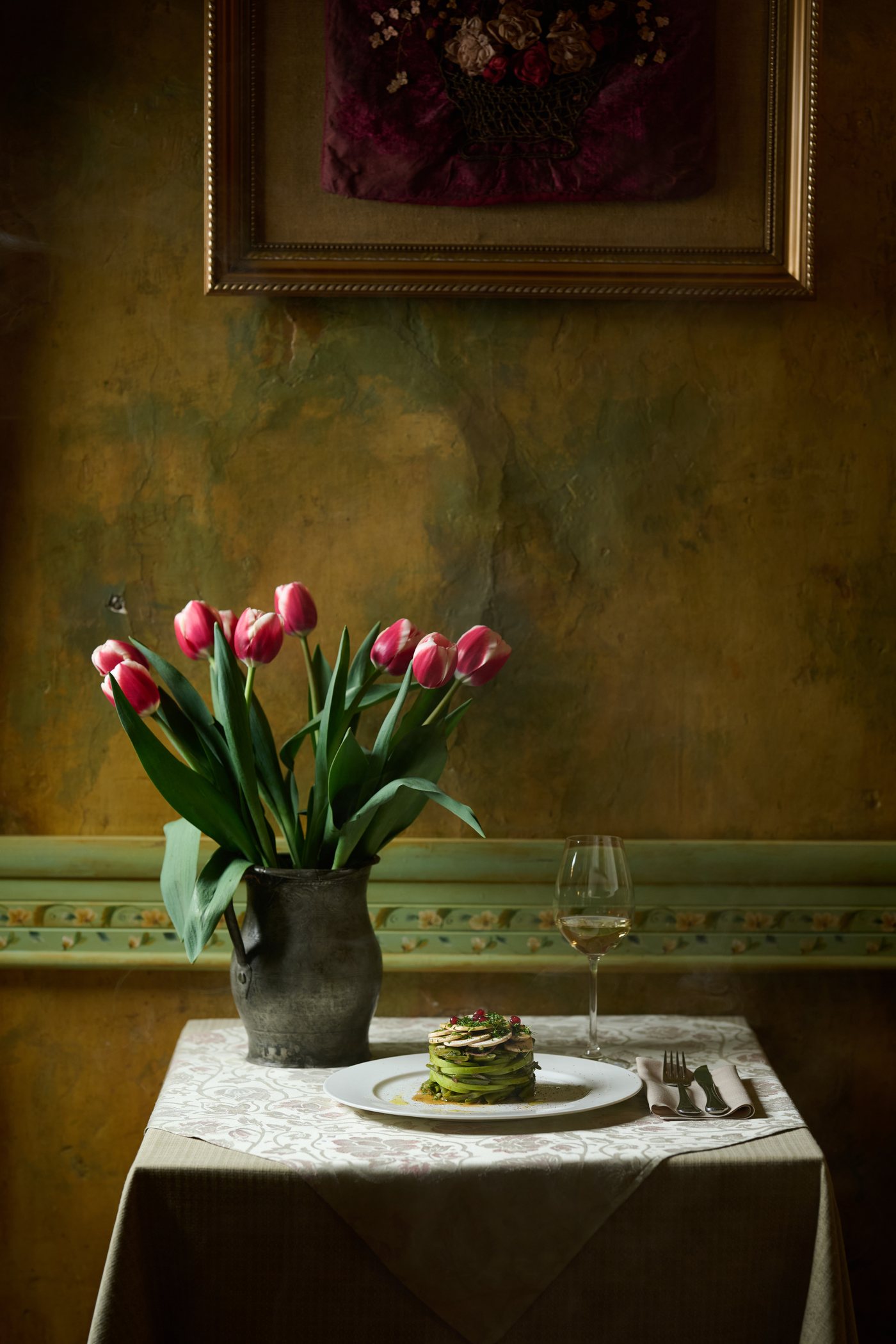 Pink tulips and candle on a quiet table